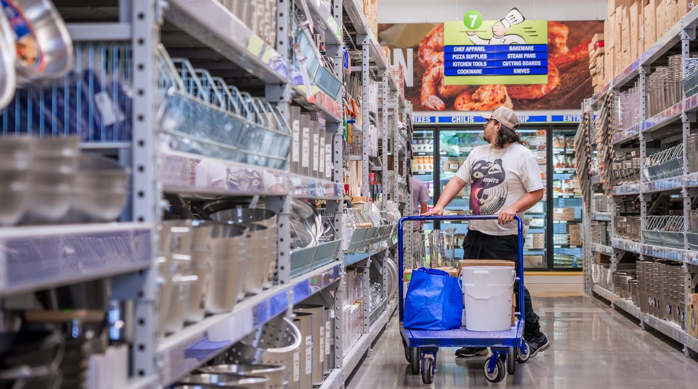 a warehouse worker loads supplies from a cart